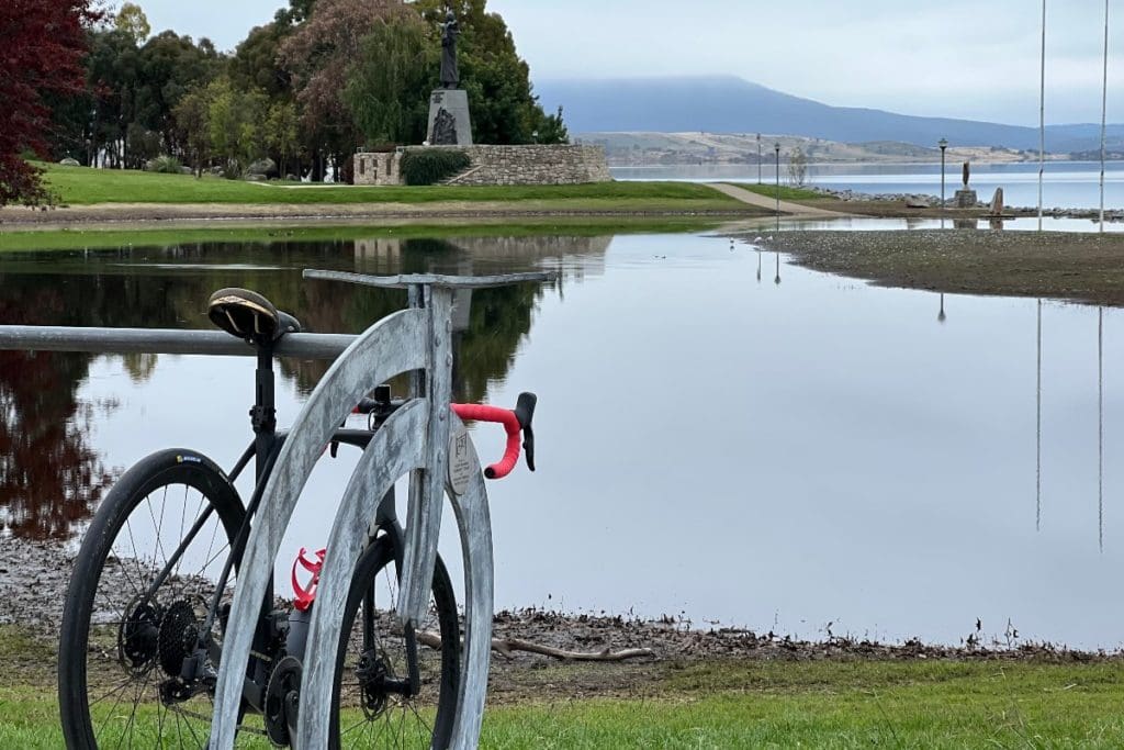 A stylish bike rack in front of the flood peaked Lake Jindabyne