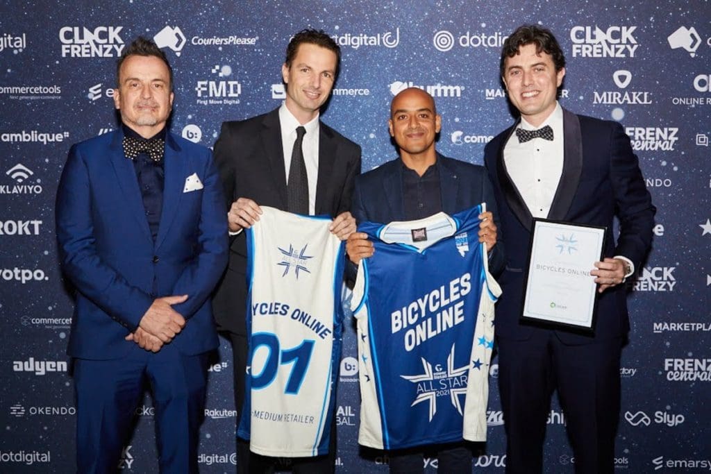 James, Jono and Bicycles Online Marketing Manager Rodrigo Sousa (second from right) receive their singlet prizes for winning ‘best small-medium retailer’ at the Power Retail All Star Bash, Australia’s awards for the e-commerce industry. Rodrigo was the first employee James and Jono hired during the business's infancy. Photo credit: Bicycles Online