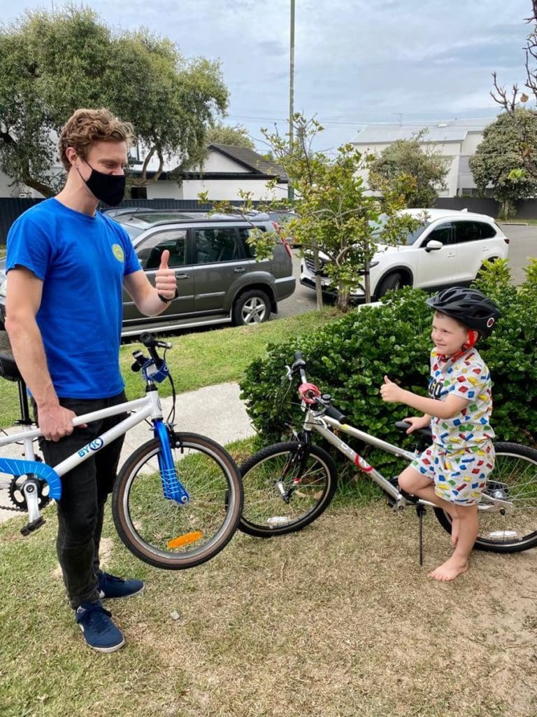 Fergus shares the excitement of a bike upgrade with one of his young customers.