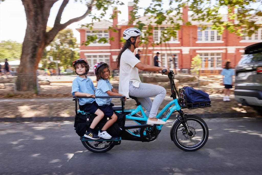 Woman and two children riding a bike