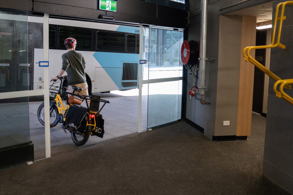 Person leaving building with bike