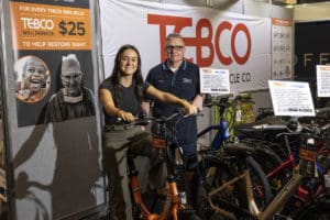 Two people at bike expo stand