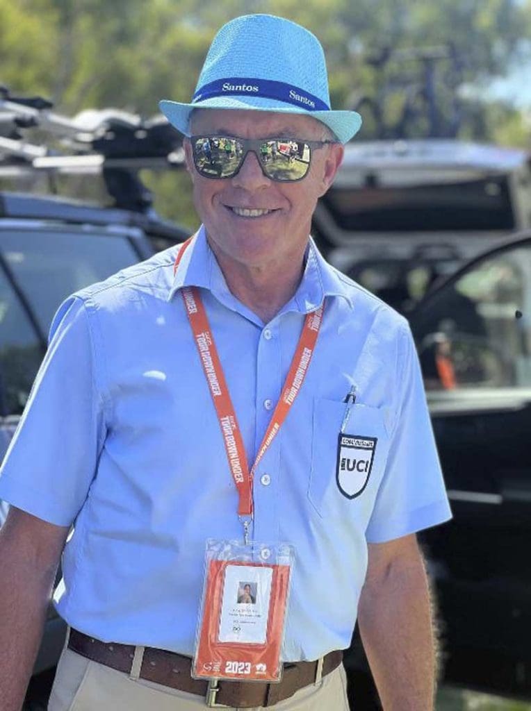 portrait of man at cycling event with official badge