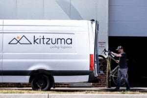 Person loading bicycle into delivery van