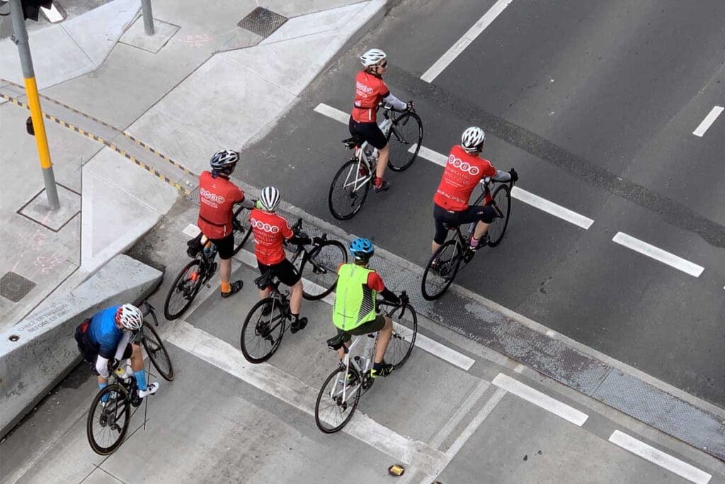 Cyclists riding on road.