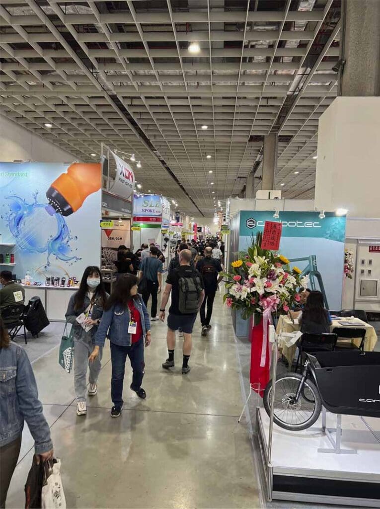 People walking through Taipei Cycle event