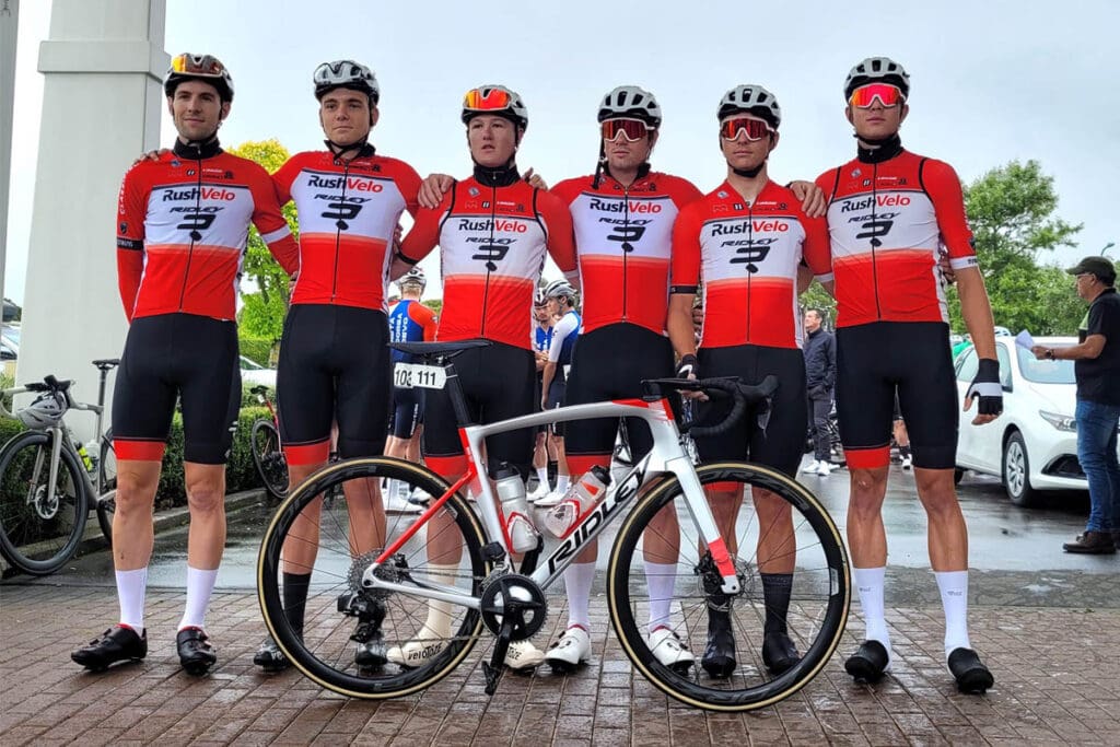 Bike racing team posing with bike