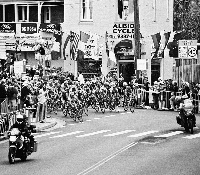 Spectators crowd the footpath outside Albion Cycles to watch the 2000 Sydney Olympics men’s road race.