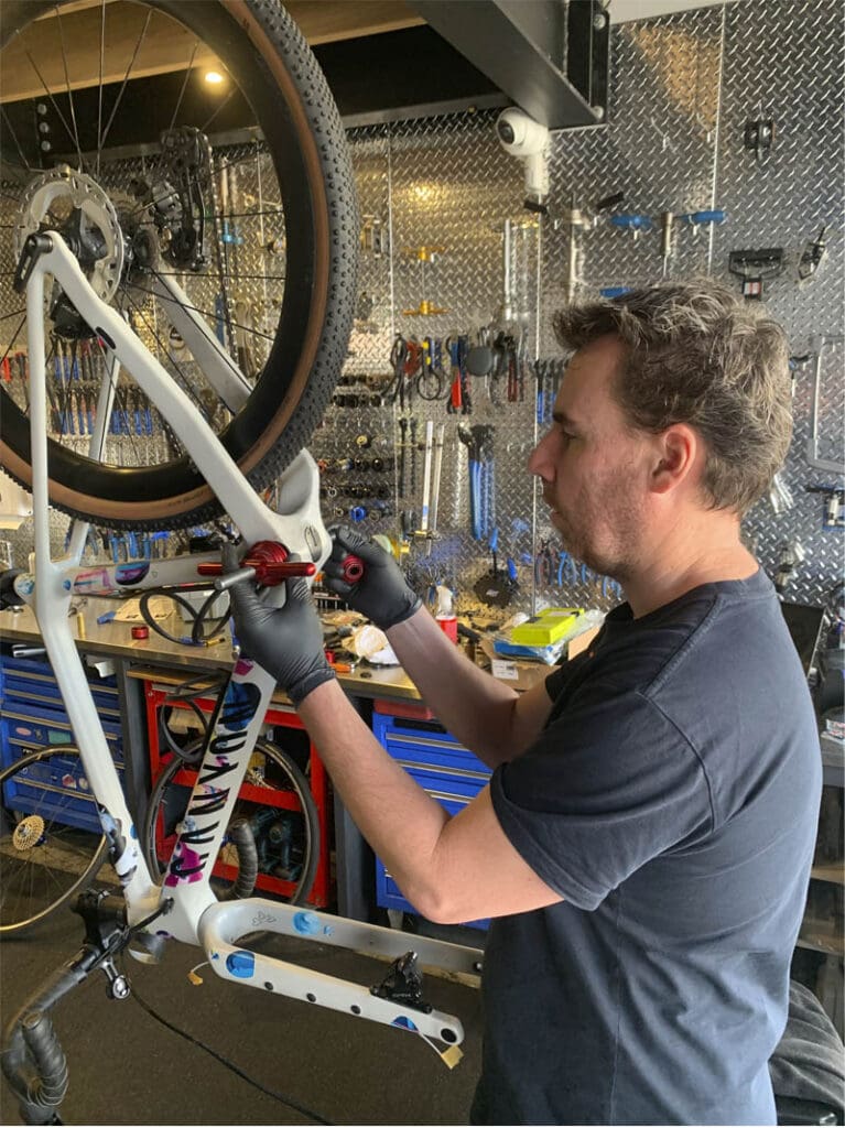 Bike mechanic working on a bike in a workshop