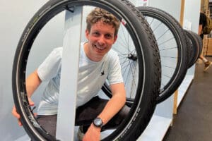 Man posing with recycleable tyre display