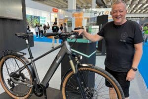 Man standing with bike at expo