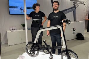 Two people with ebike on display at expo