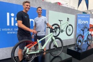 Two men standing with bike at expo