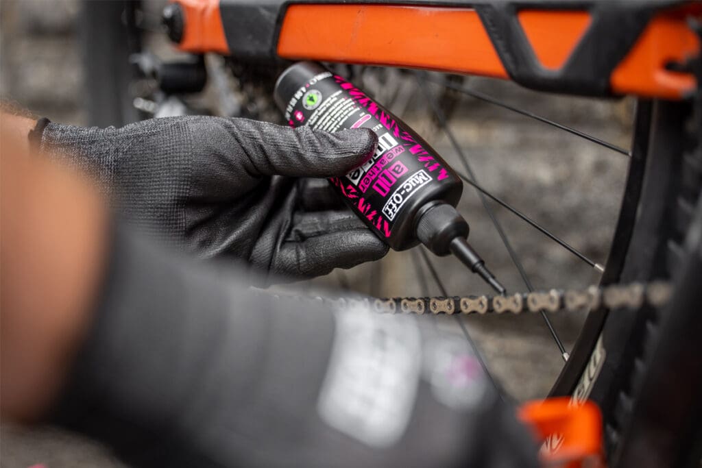 Person using bicycle lubricating product