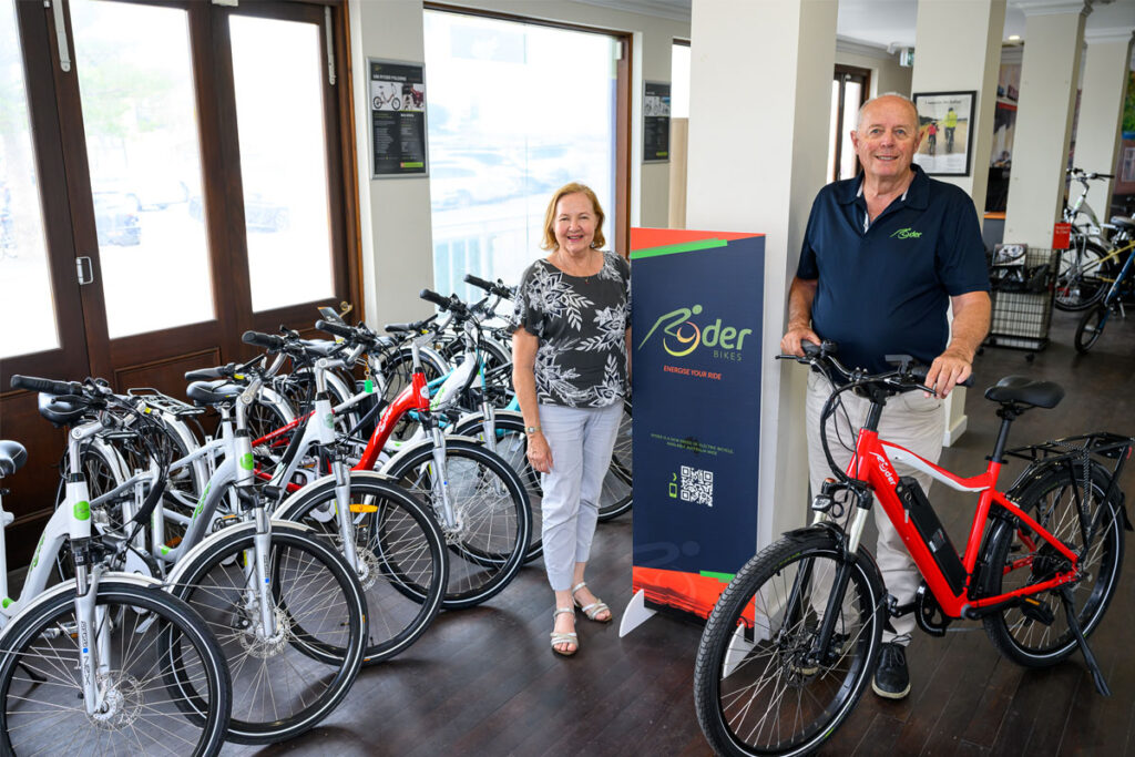 Two people standing in bicycle shop showroom