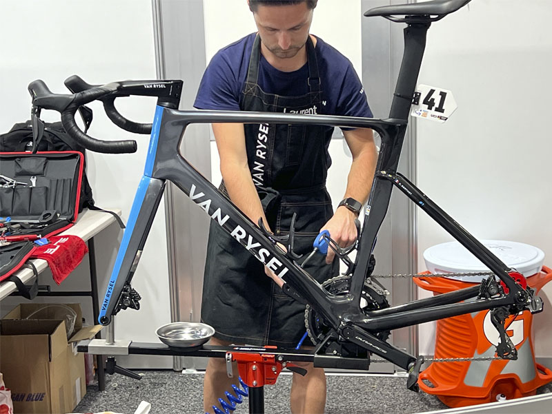 Bike mechanic working on race bike