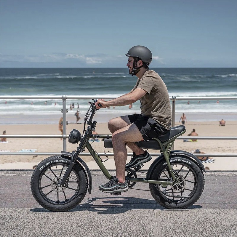 Person riding e-bike along beach promenade