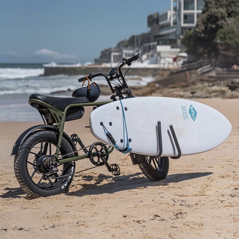 E-bike parked on the beach with surfboard in surfboard holder accessory