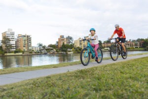 Father and daughter riding on bicycle track