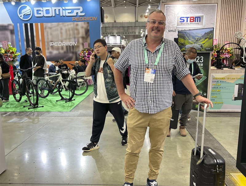 Man standing in bicycle expo auditorium