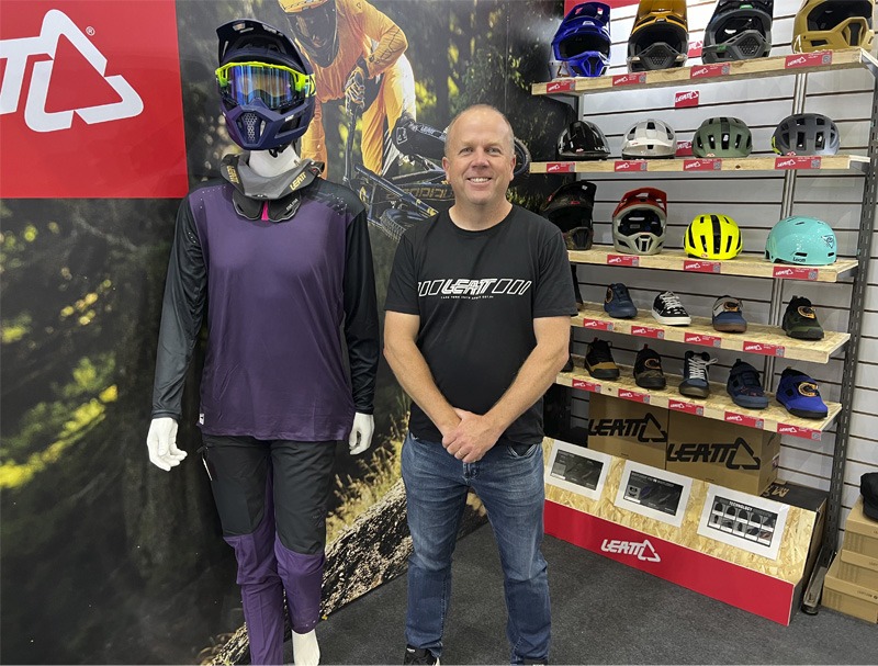Man standing with helmet display at bike expo