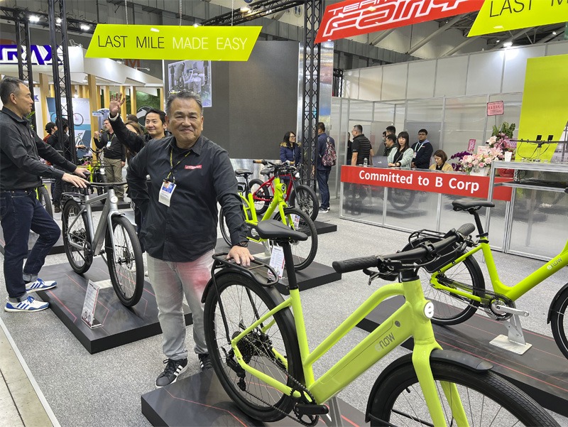 Man standing with bicycle on display at expo