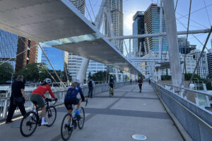 Two cyclists crossing a bridge