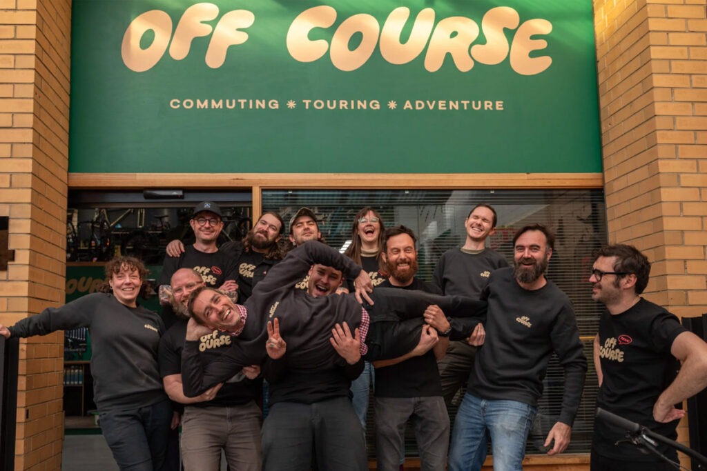 A bicycle shop team at the front of store exterior