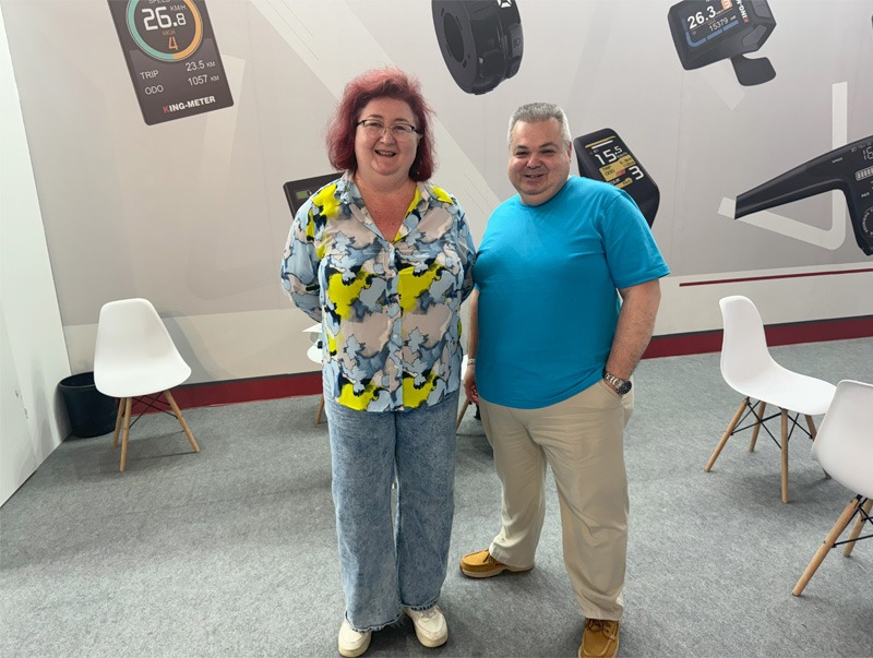 two people standing in exhibition hall of bicycle expo