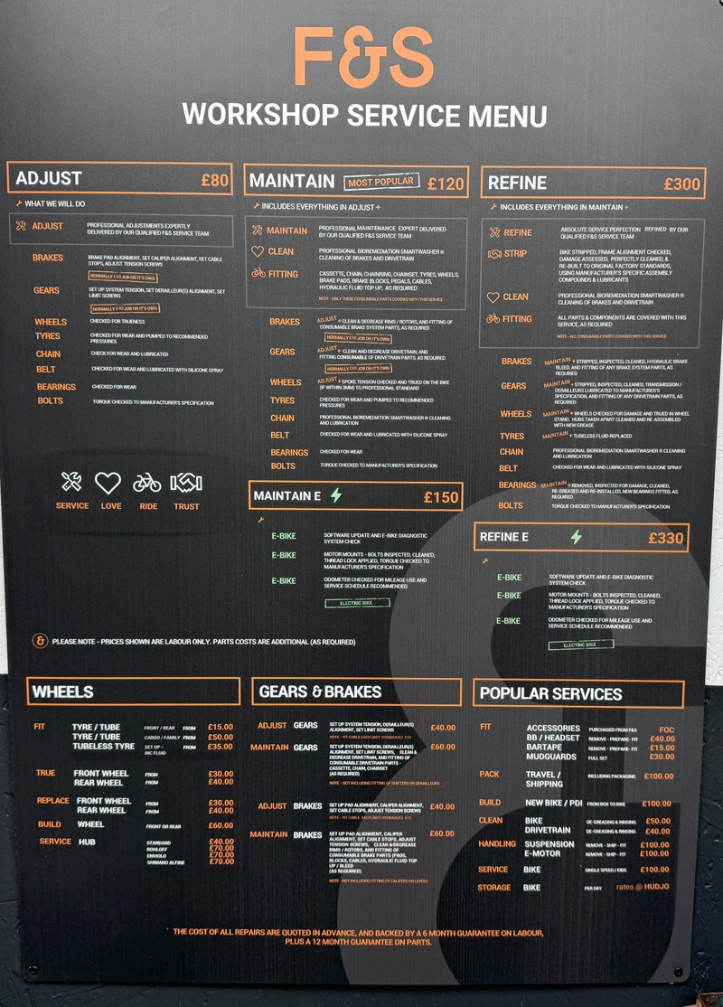 Bike workshop pricing menu displayed on wall