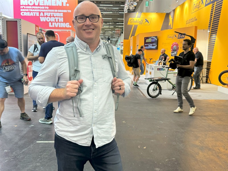 Man standing in exhibition hall of bicycle expo