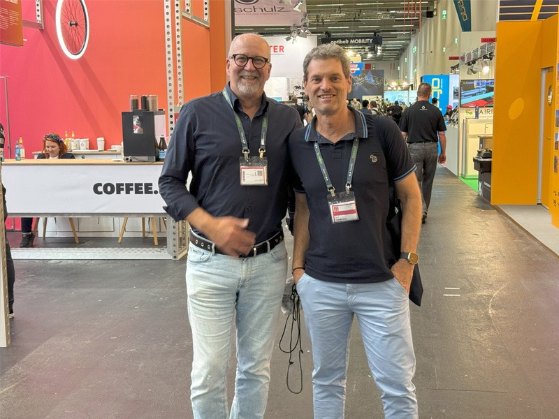 Two men standing in exhibition hall of bicycle expo