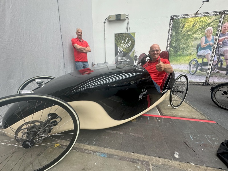 Person sitting in a peddle powered custom vehicle