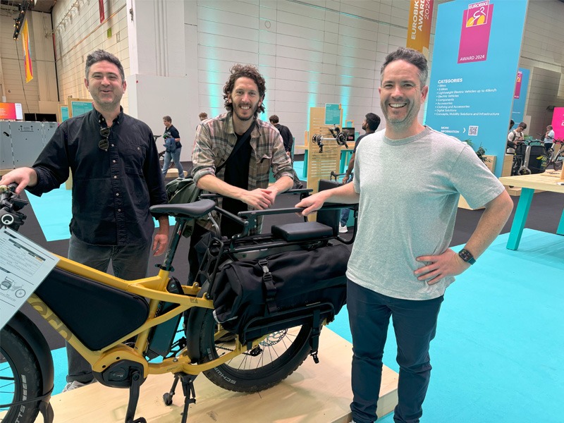 Men standing with bicycle at bike expo