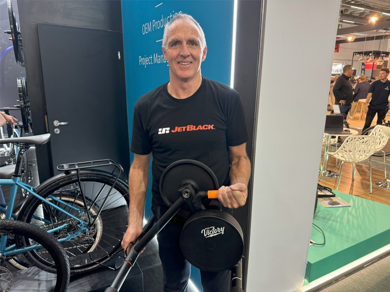 Man standing in bicycle at bike expo