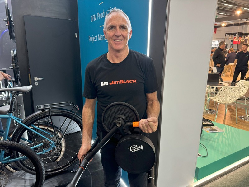 Man standing with bike at bicycle expo