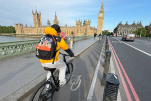 Person riding bike accross London bridge