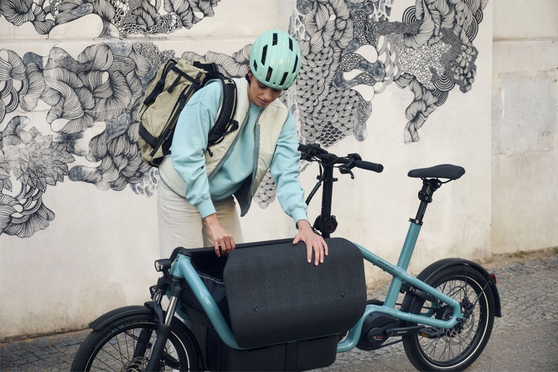 Product shot of a person with cargo bicycle