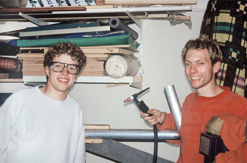 An old photo of two men with tools in a workshop