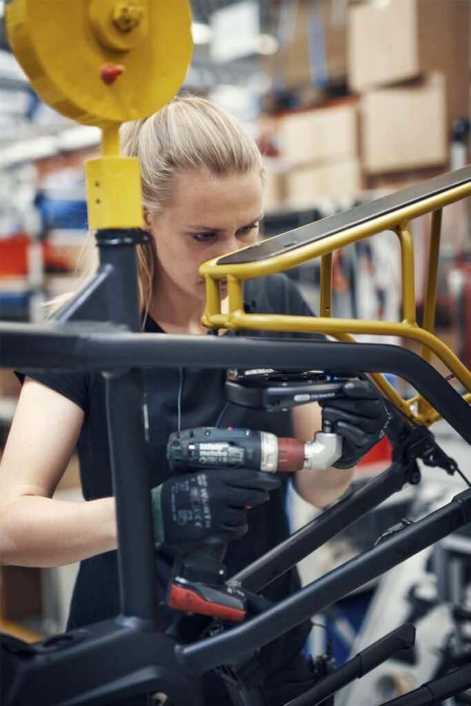 A production worker using machinery