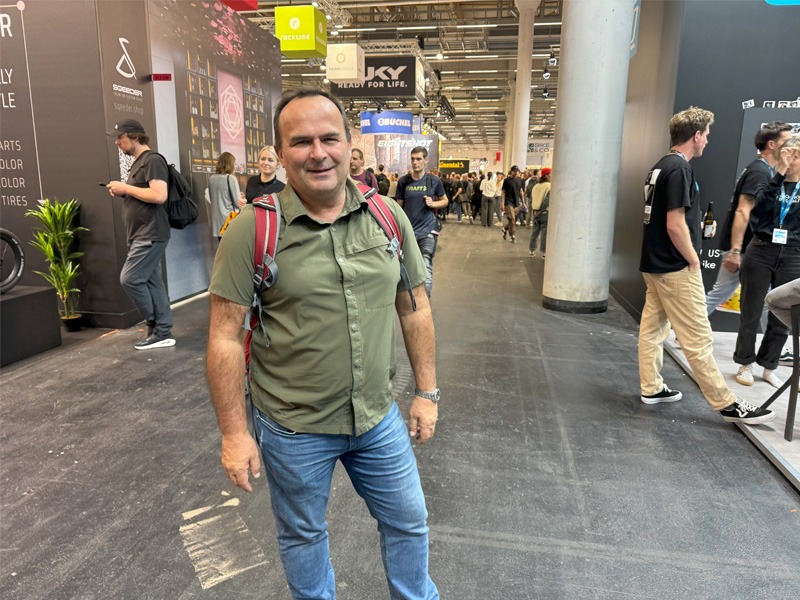 Man standing in exhibition hall of bicycle expo