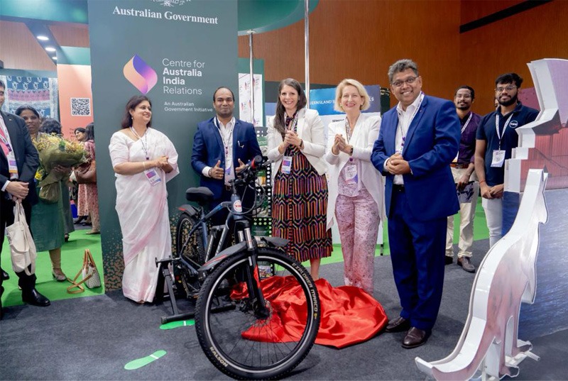 Group of people standing with bicycle in a professional setting.