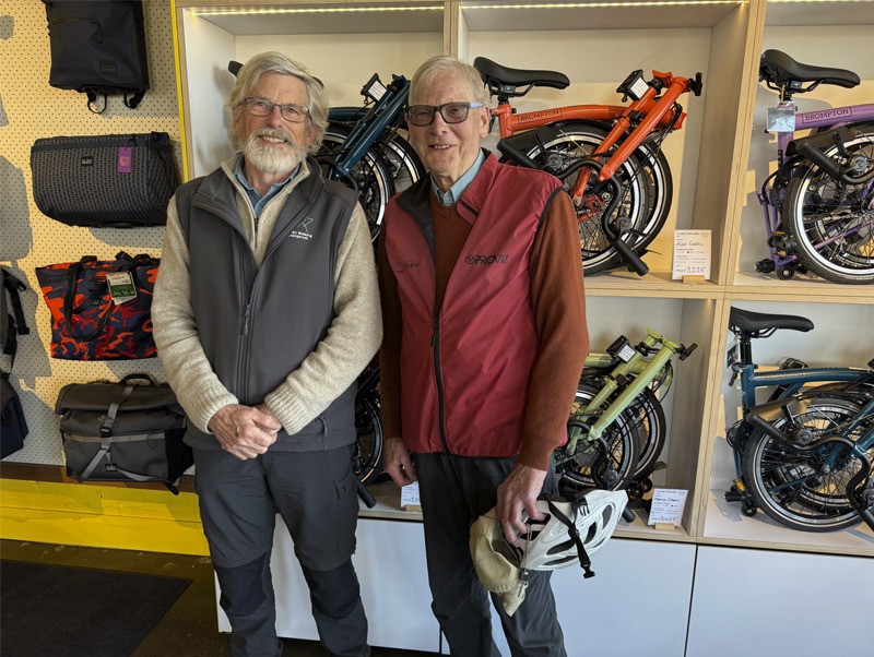 Two men standing in a bicycle shop