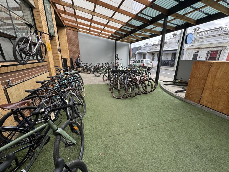 Bicycles parked at the front of a bike store