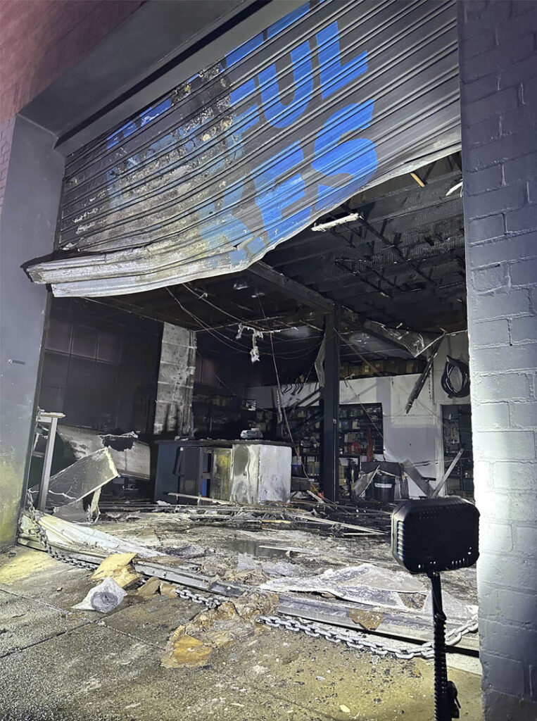 Fire damaged roller door and shop front.