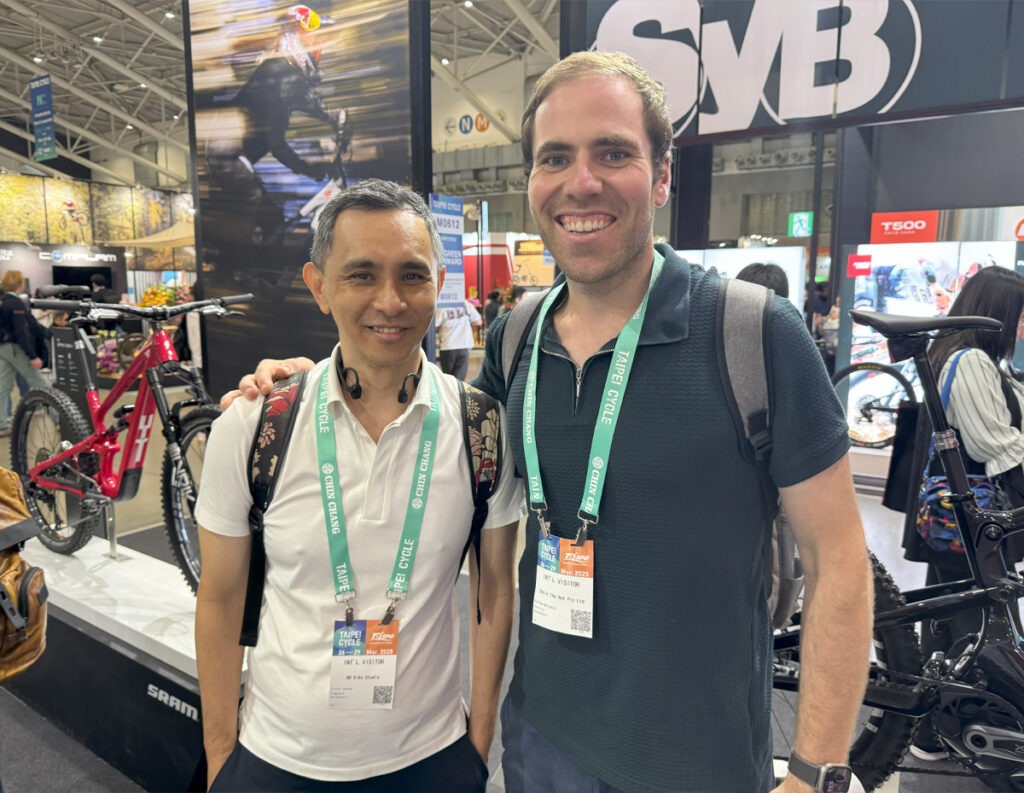 Two men wearing expo badges.