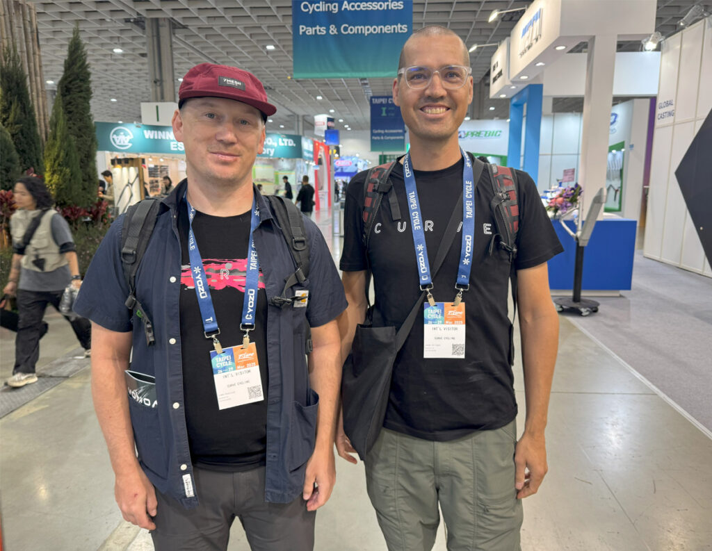 Two men wearing expo badges