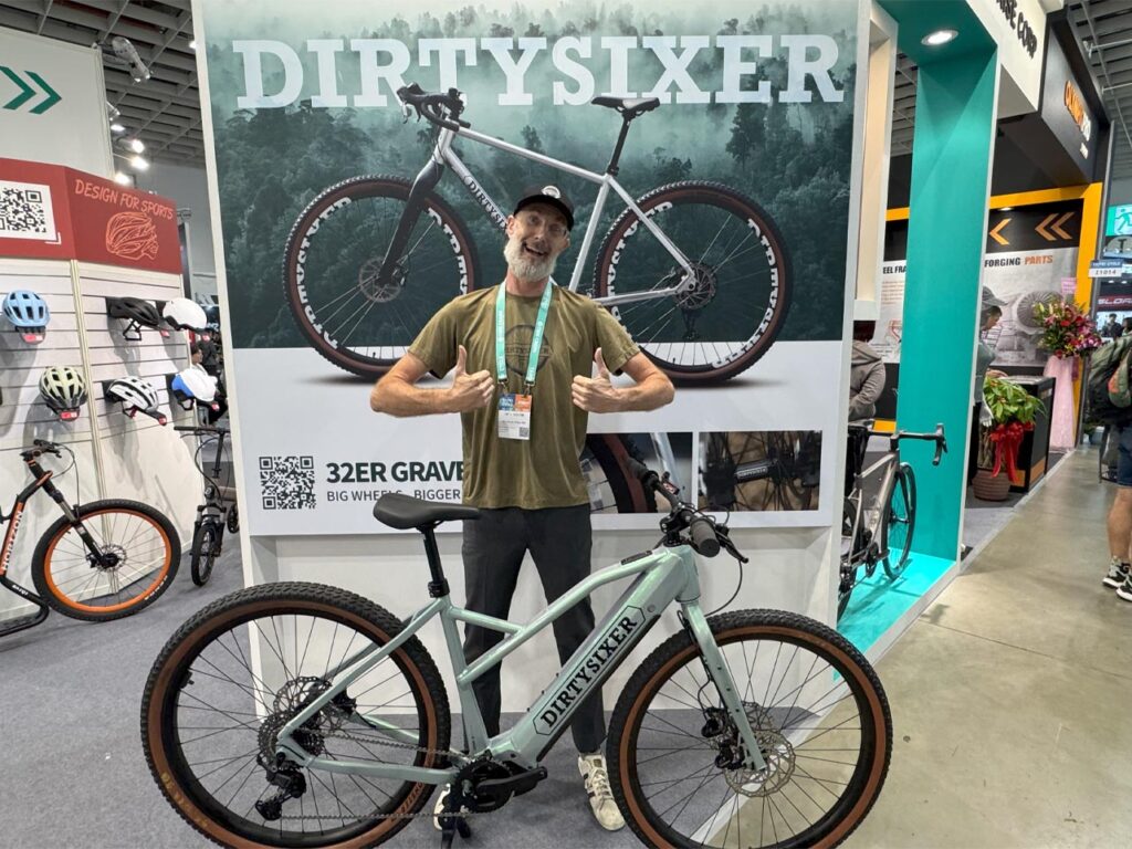 Man with bicycle display at expo