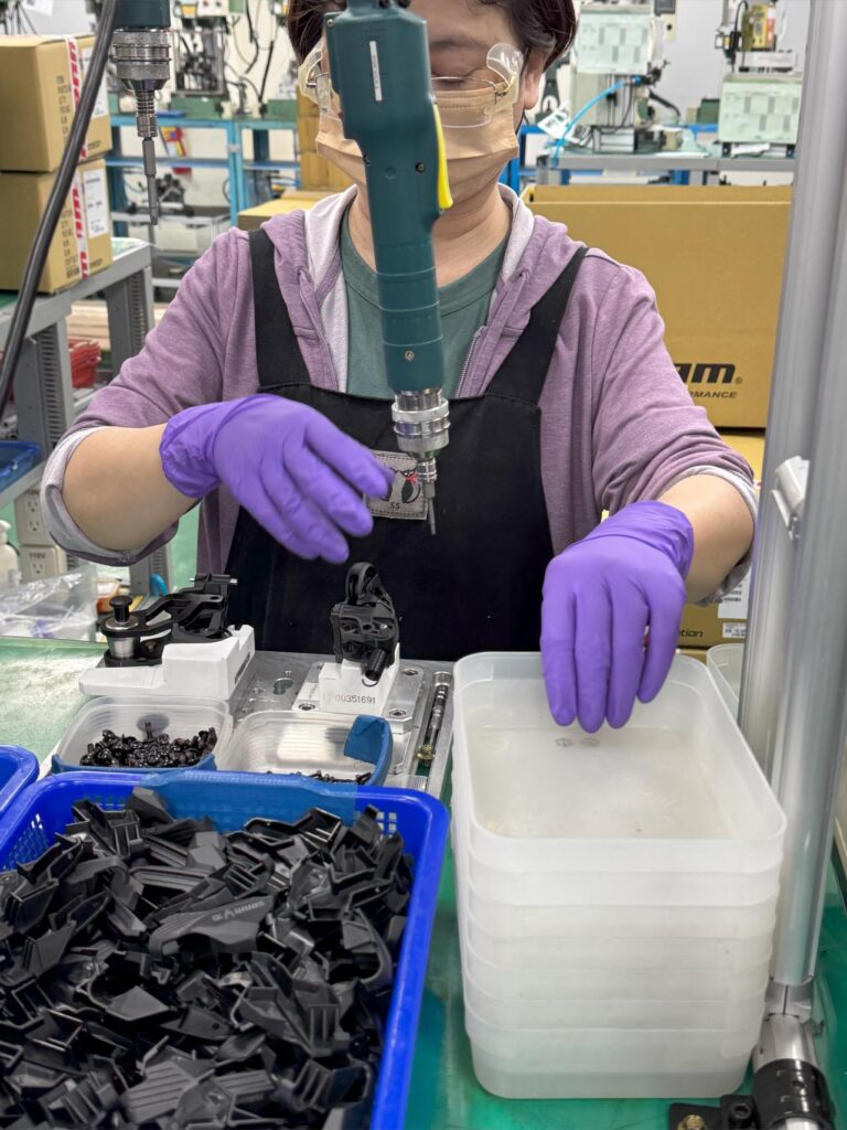 Person working on components in a factory