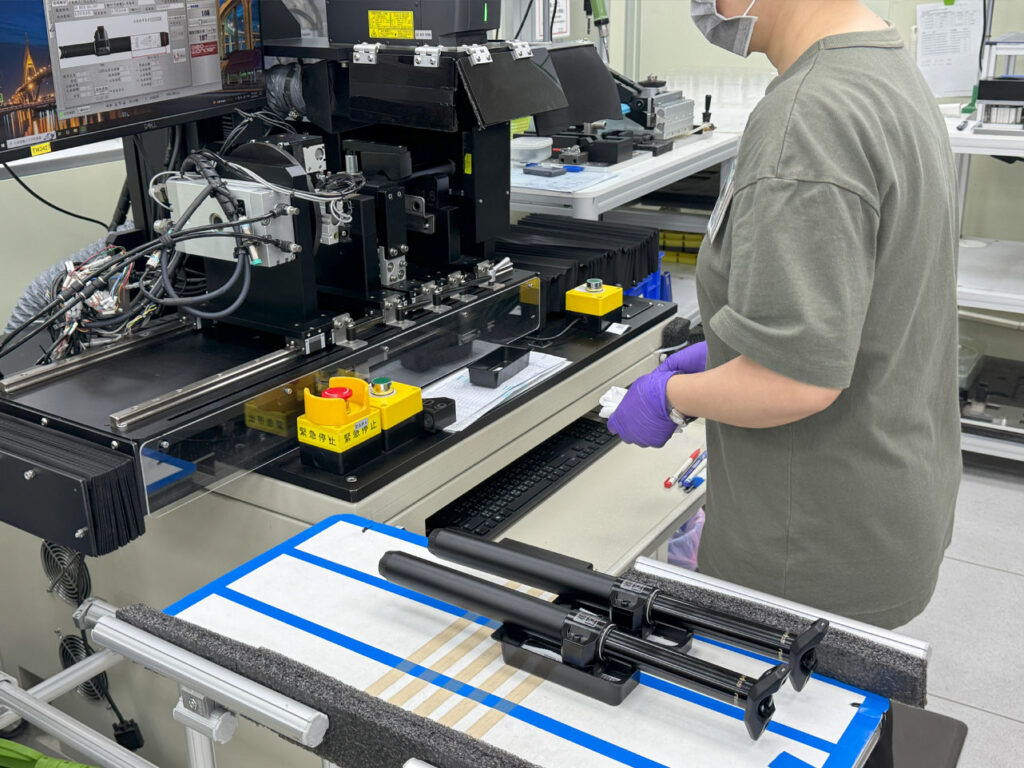 Person working on components in a factory